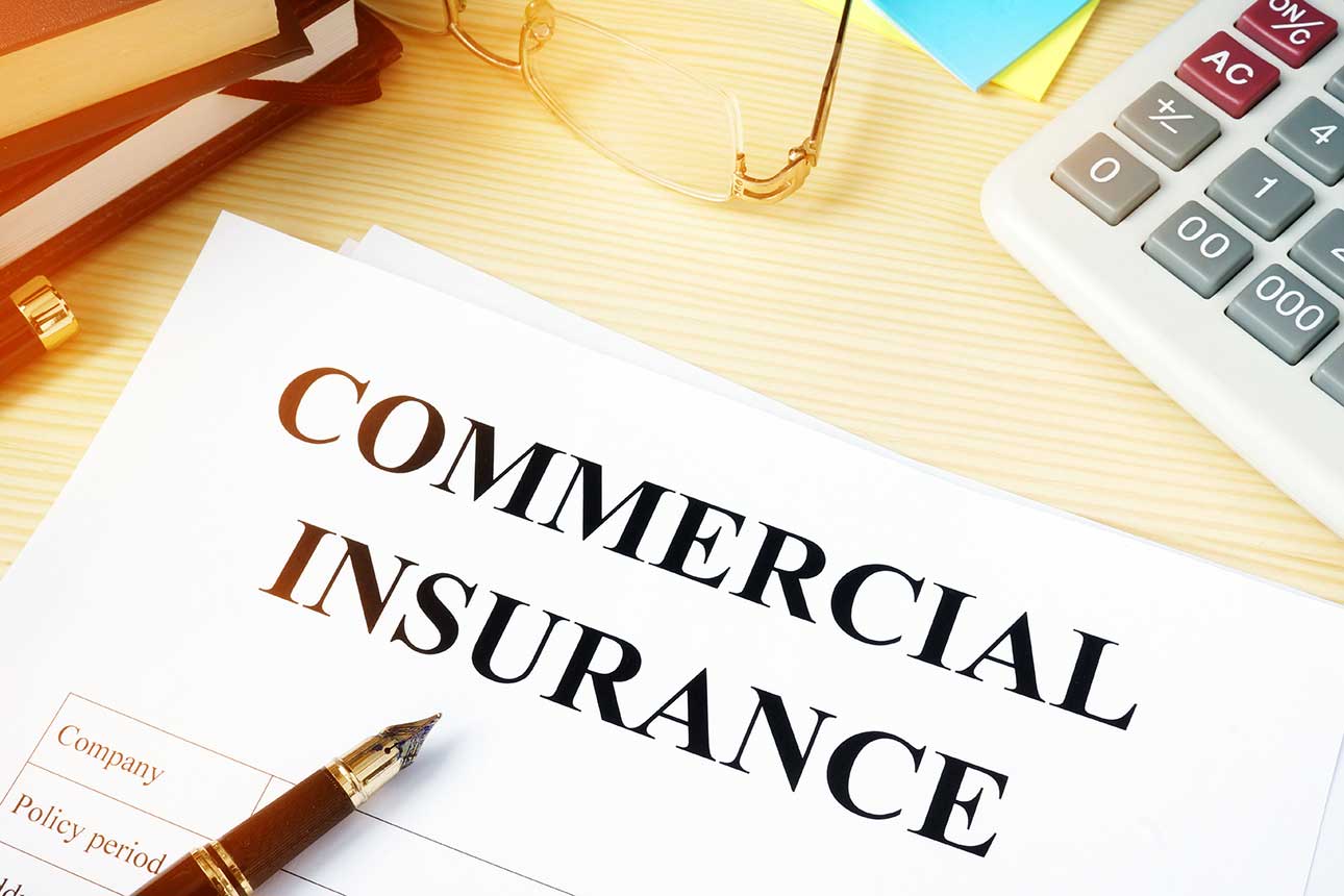 Commercial insurance on paper with pen contracts.