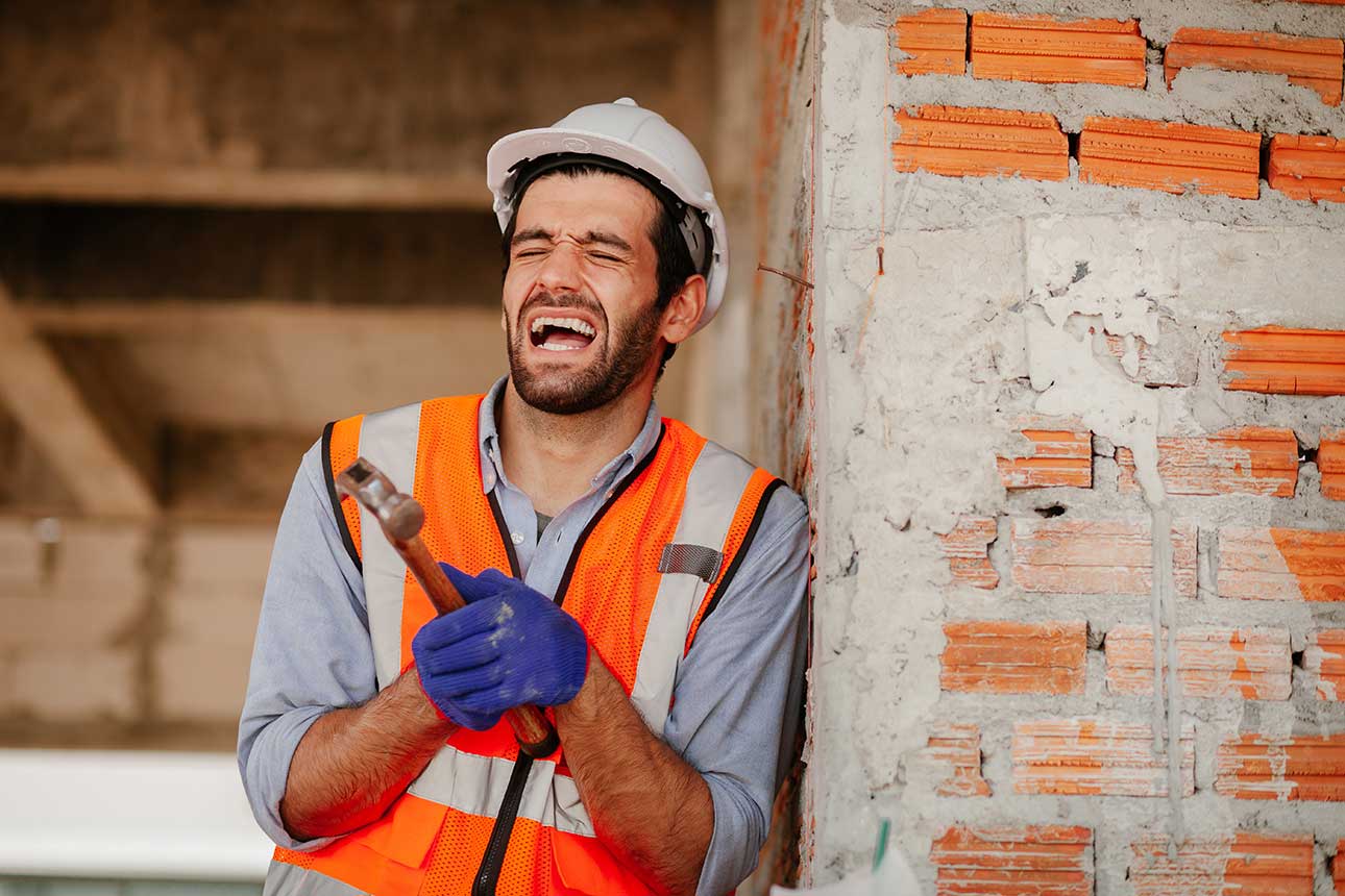 Male Construction worker in pain after making renovation mistake