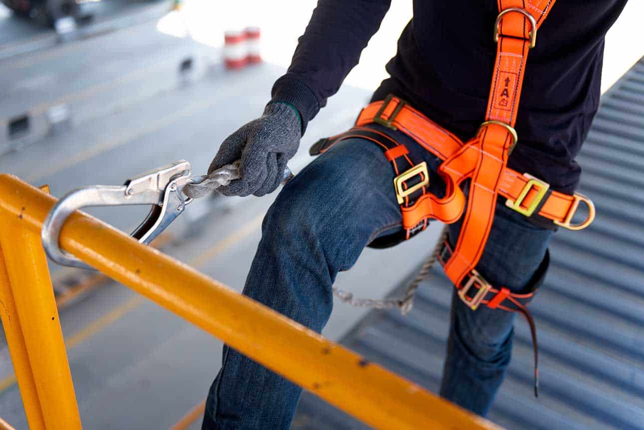 Worker in safety harness clipping in to stable point.